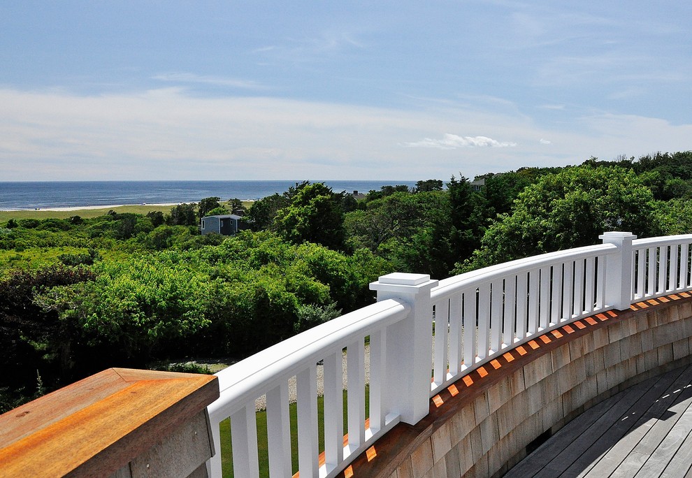 Example of a beach style deck design in Boston with no cover