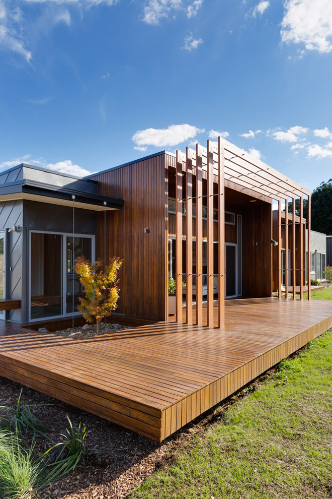 Photo of a contemporary back terrace in Melbourne with a roof extension.