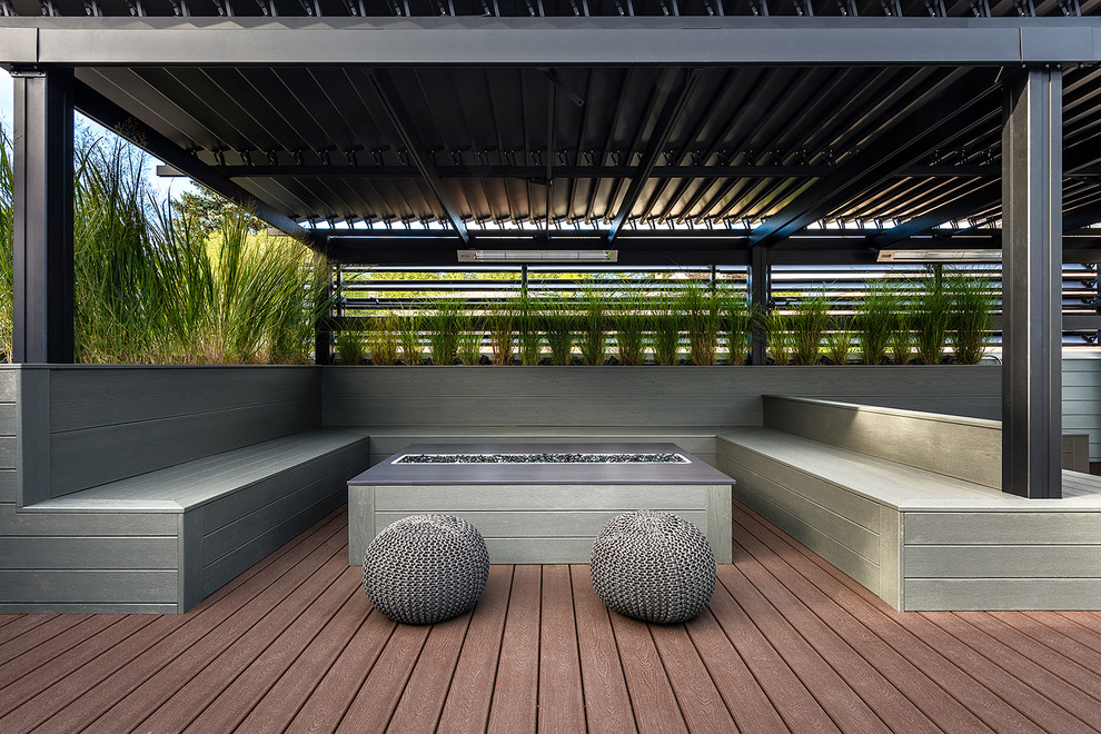 Large minimalist rooftop deck photo in Chicago with a fire pit and a pergola