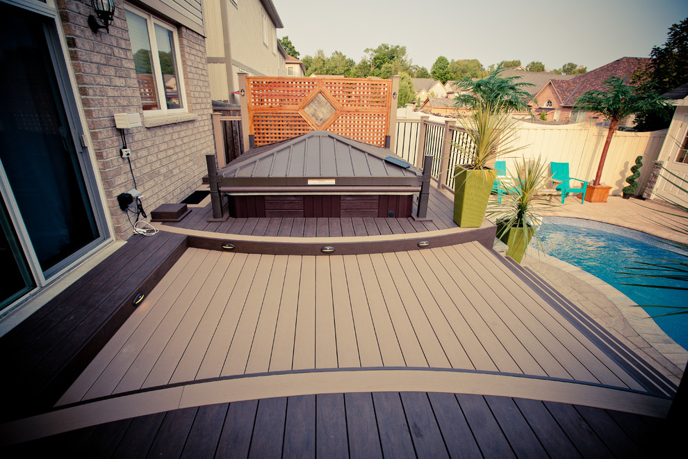 Medium sized beach style back terrace in Toronto with a water feature.