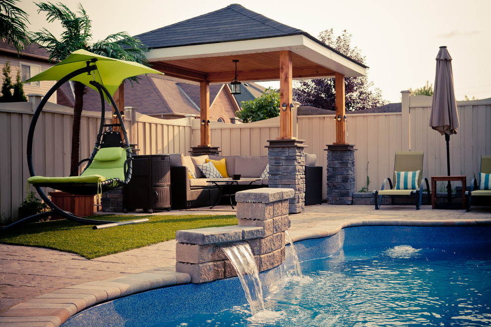 Inspiration for a huge coastal backyard water fountain deck remodel in Toronto with a pergola