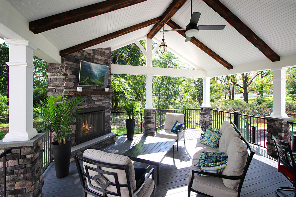 Inspiration for a mid-sized coastal backyard deck remodel in Philadelphia with a fireplace and a roof extension