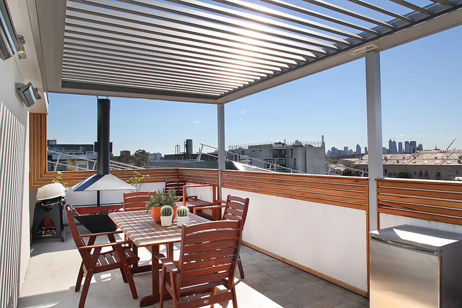 Inspiration for a large contemporary roof terrace in Melbourne with a roof extension.