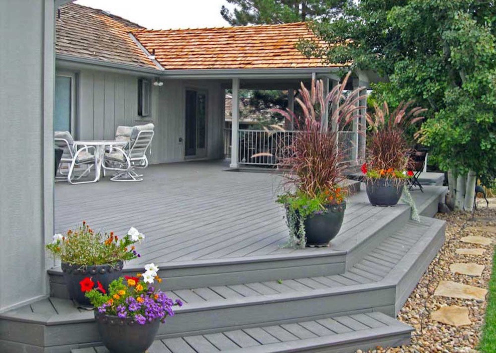 Example of a mid-sized classic backyard deck design in Denver with no cover