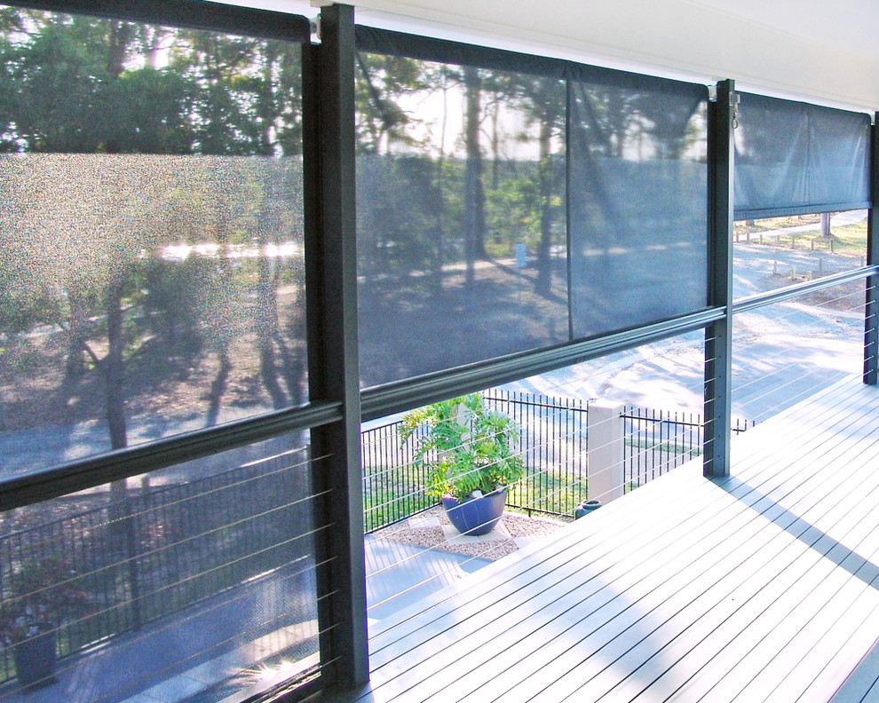 Example of a trendy side yard deck design in Sydney with an awning
