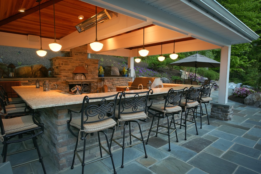 Design ideas for a large traditional back terrace in DC Metro with an outdoor kitchen and a roof extension.