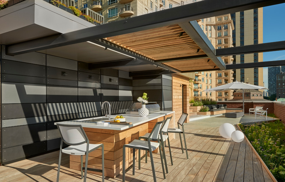 Inspiration for a large contemporary rooftop outdoor kitchen deck remodel in Chicago with a pergola