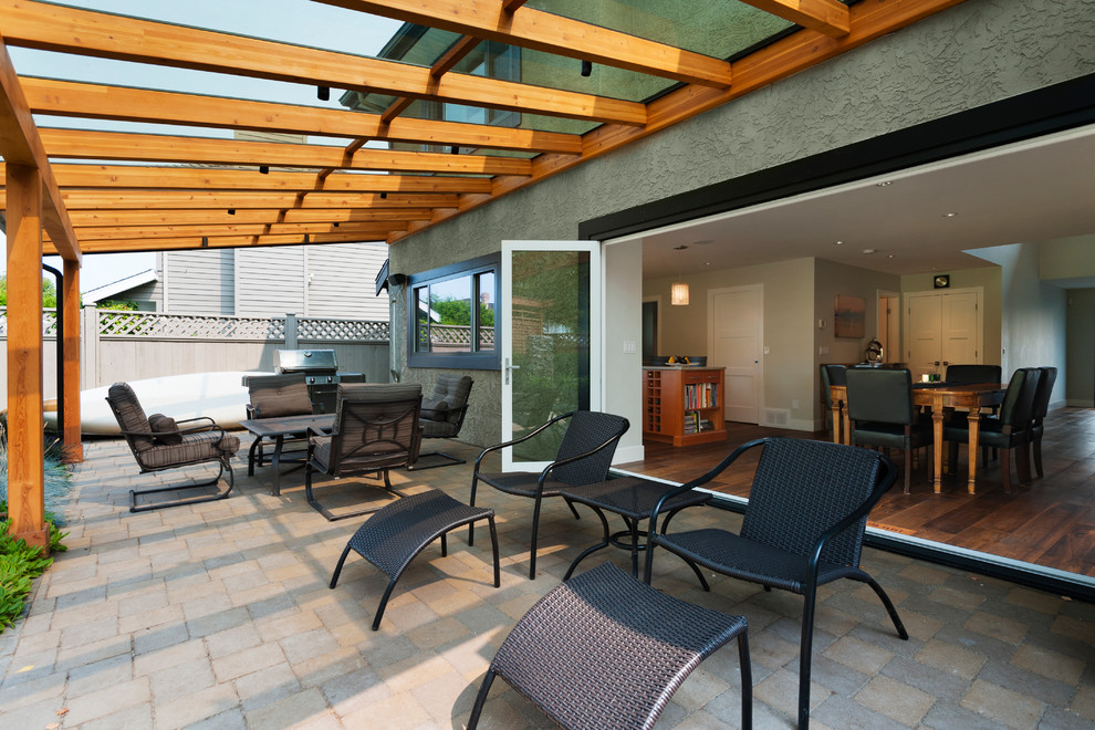 This is an example of a large classic back terrace in Vancouver with an awning.