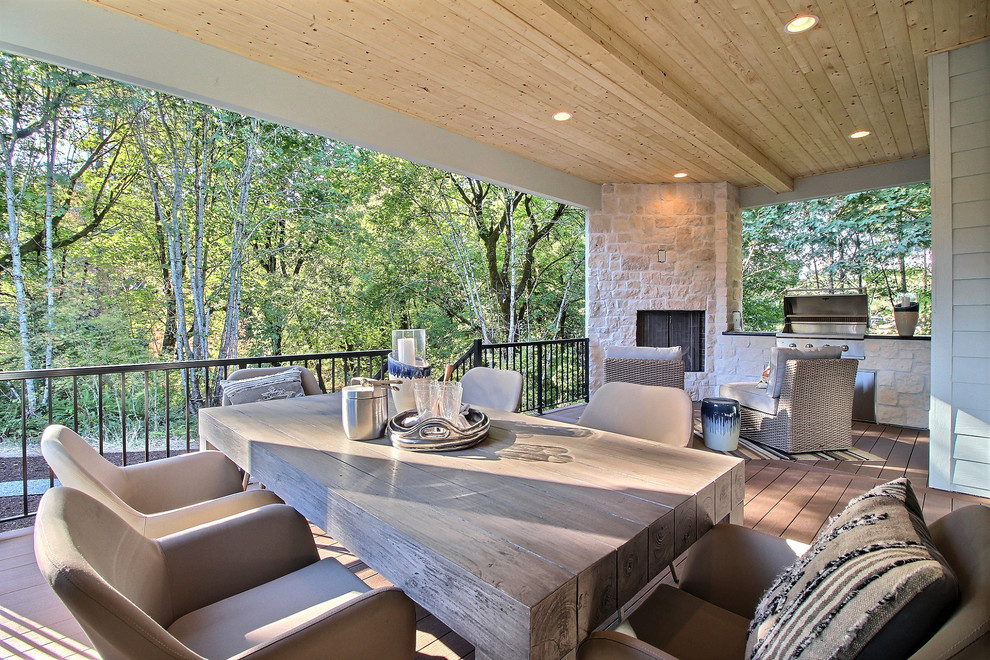Example of a huge arts and crafts backyard outdoor kitchen deck design in Portland with a roof extension