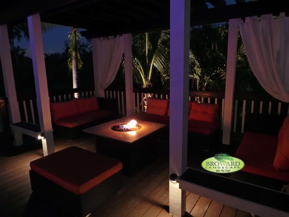 Inspiration for a contemporary back terrace in Miami with a fire feature and a pergola.