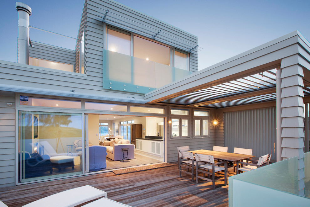 Deck - contemporary deck idea in Auckland with a pergola