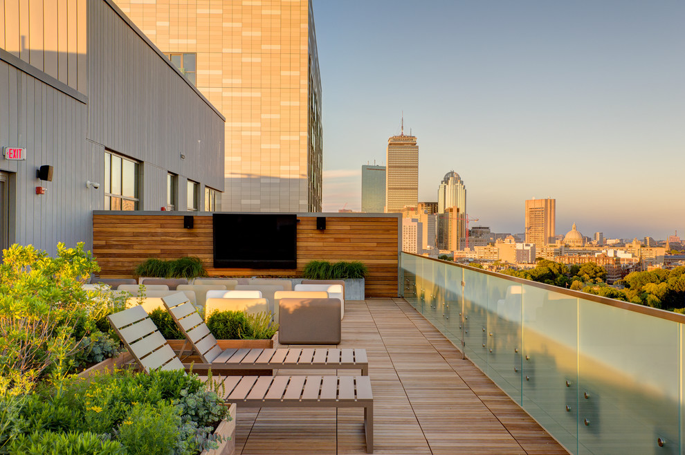 Large trendy rooftop deck container garden photo in Boston with no cover