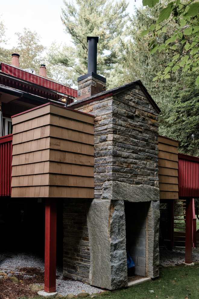 Idée de décoration pour une grande terrasse arrière design avec une cuisine d'été et un auvent.