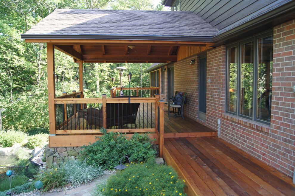 Inspiration for an expansive back terrace in Other with a roof extension.