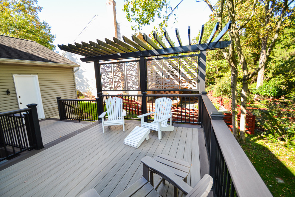 Deck - mid-sized asian backyard ground level wood railing deck idea in DC Metro with an awning