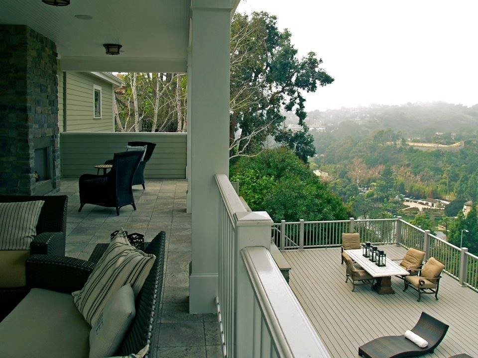 This is an example of a large coastal back terrace in Los Angeles with a roof extension.