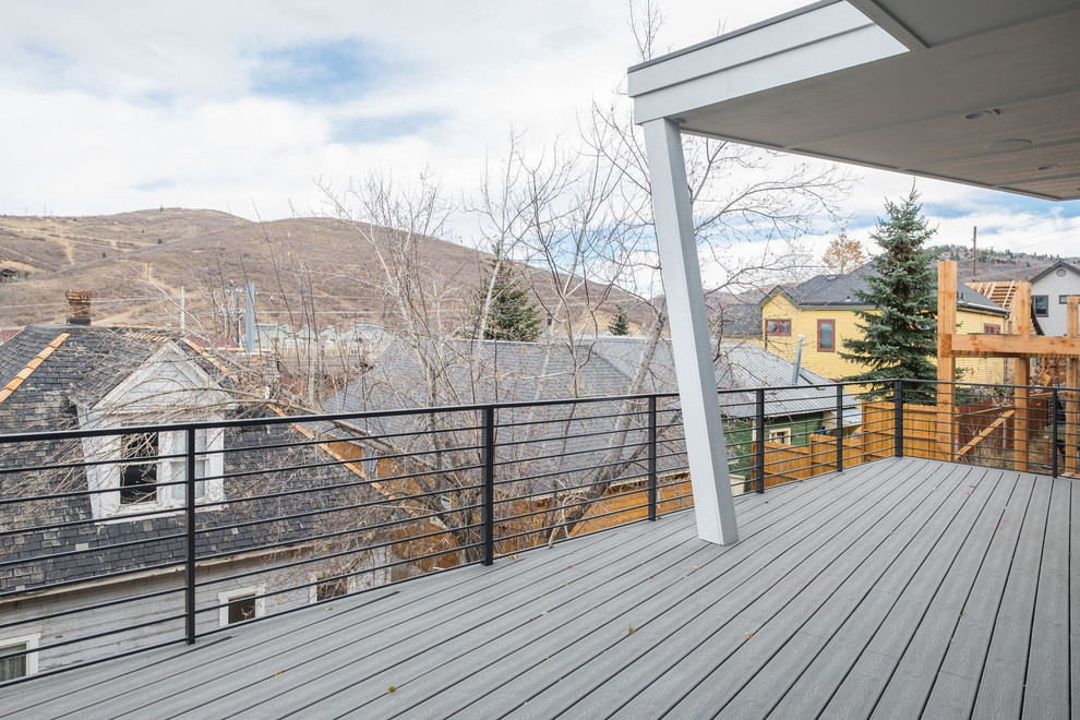 Inspiration for a large transitional backyard deck remodel in Salt Lake City with a roof extension