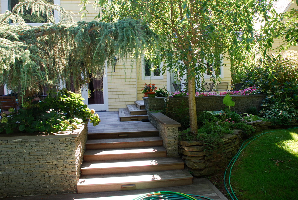 Example of a mid-sized eclectic backyard deck container garden design in New York