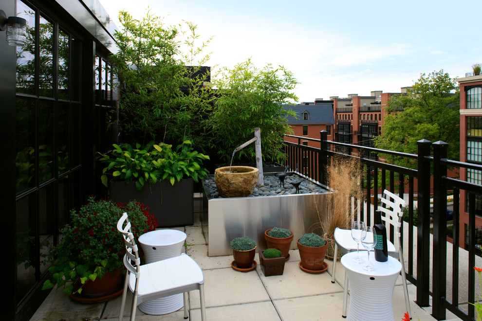 Medium sized contemporary back terrace in Other with a water feature and no cover.