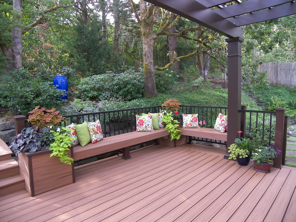 Mid-sized trendy backyard deck photo in Portland with a pergola