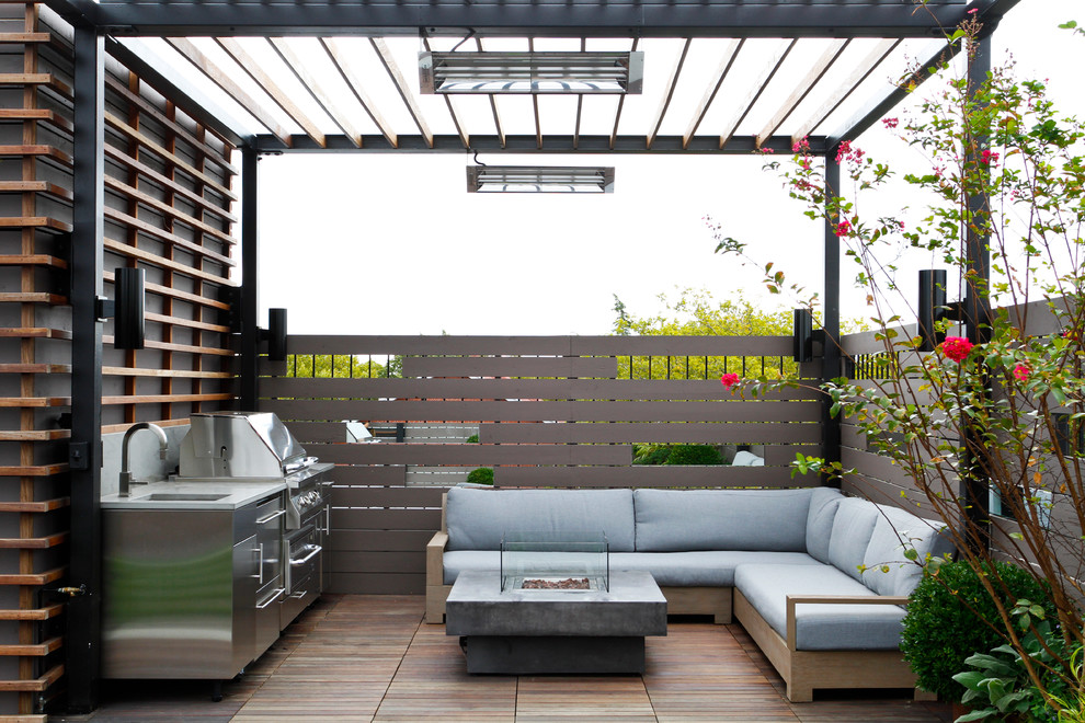 Example of a trendy deck design in New York with a roof extension