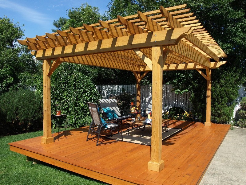 This is an example of a small classic back terrace in Grand Rapids with a pergola.