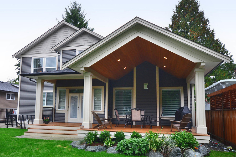 Medium sized classic back terrace in Vancouver with a roof extension.