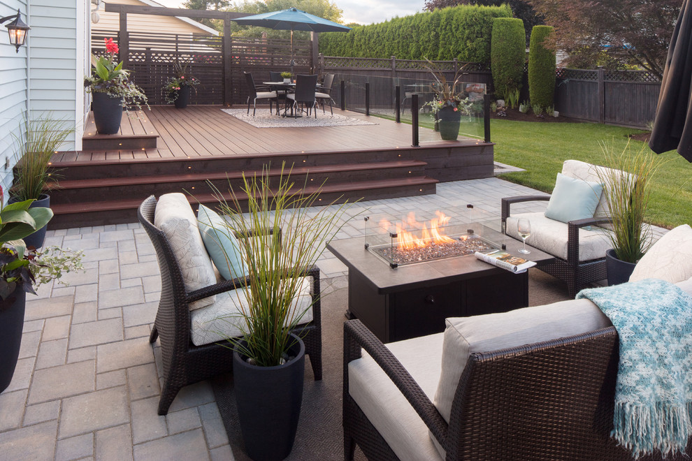 Inspiration for a large contemporary backyard deck remodel in Vancouver with a fire pit and no cover