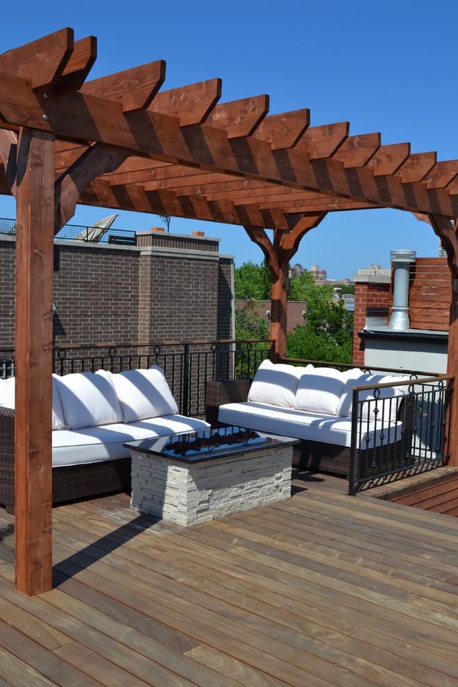 Example of a large trendy rooftop deck design in Chicago with a fire pit and a pergola