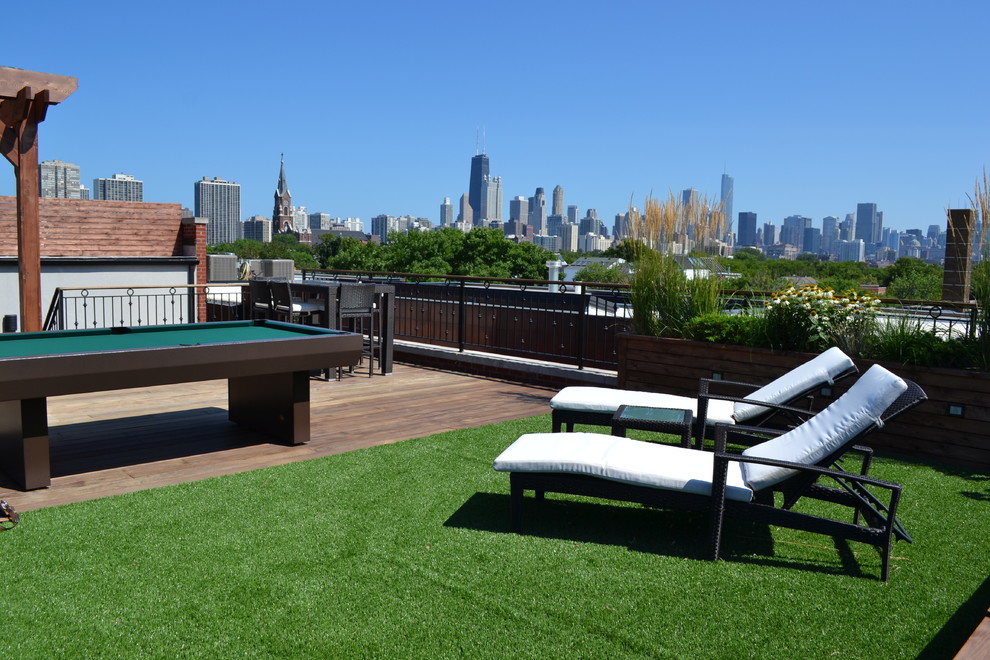 Large trendy rooftop deck photo in Chicago with a fire pit and a pergola