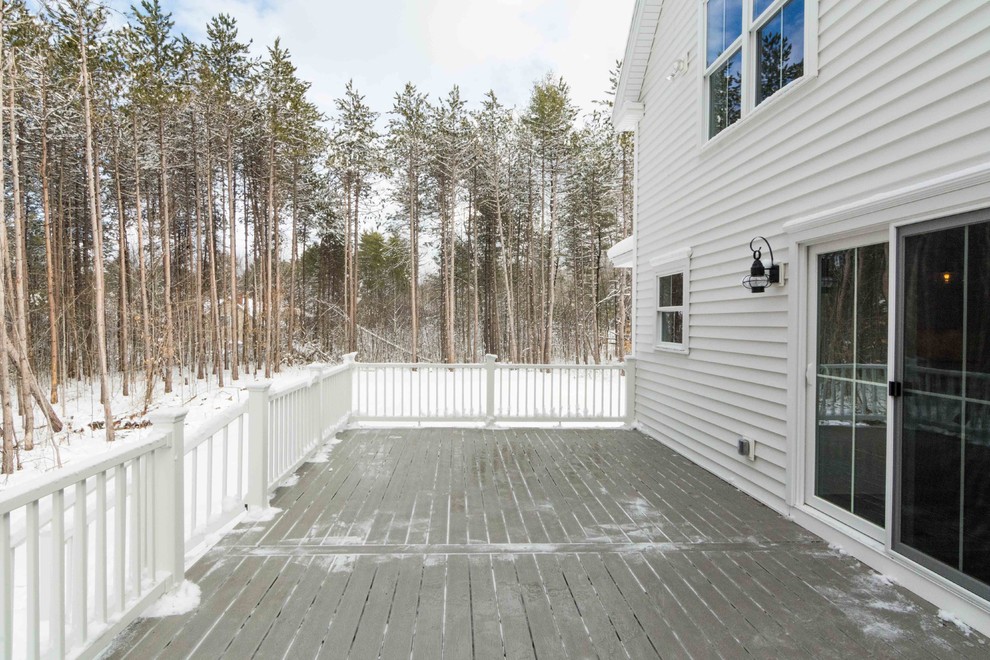 Example of a large farmhouse backyard deck design in Portland Maine with no cover