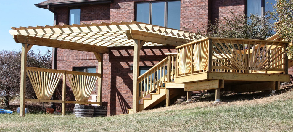 Inspiration for a small timeless backyard deck remodel in Omaha with a pergola