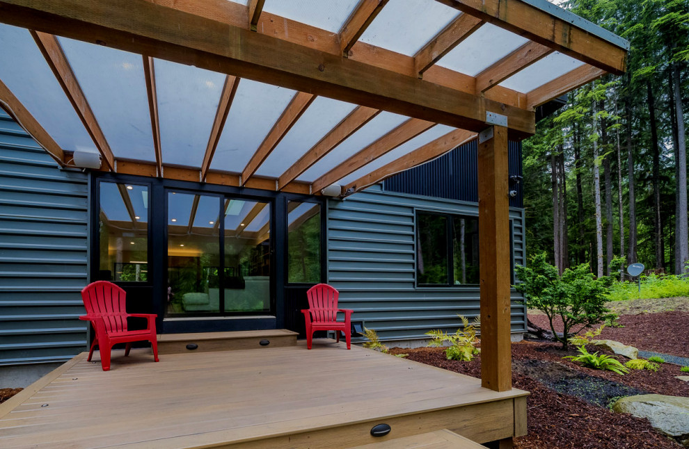 Design ideas for a medium sized modern back terrace in Seattle with a pergola.