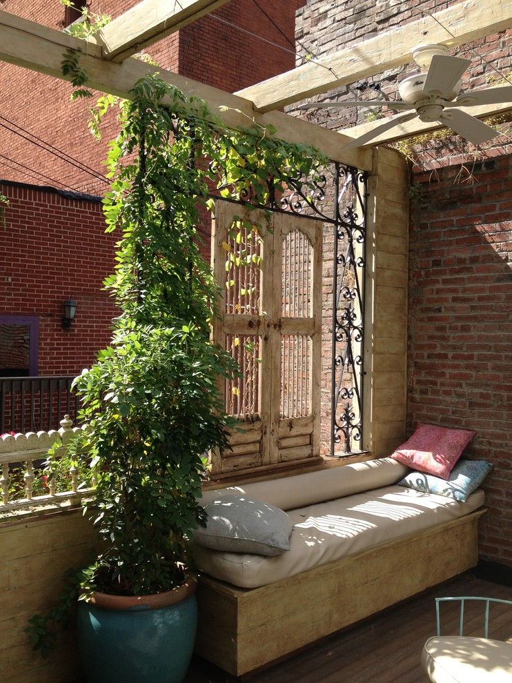 Inspiration for a timeless rooftop deck remodel in Nashville with a pergola