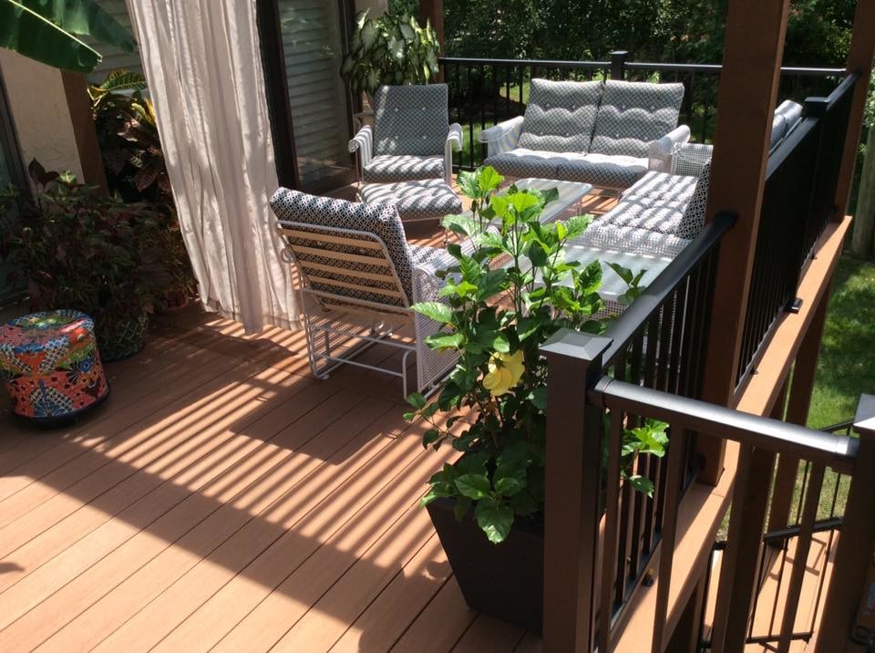 Deck - mid-sized contemporary backyard deck idea in Kansas City with a pergola