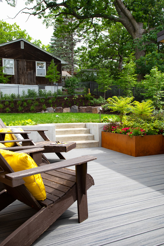 Example of a large minimalist backyard outdoor kitchen deck design in Minneapolis with a pergola