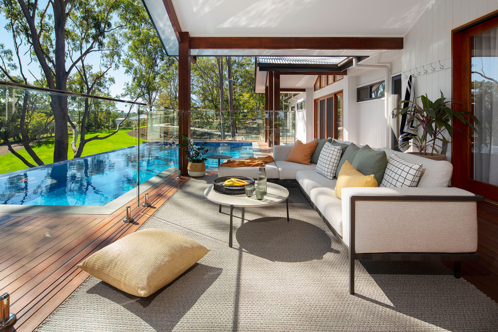Inspiration for a coastal ground level glass railing terrace in Brisbane.