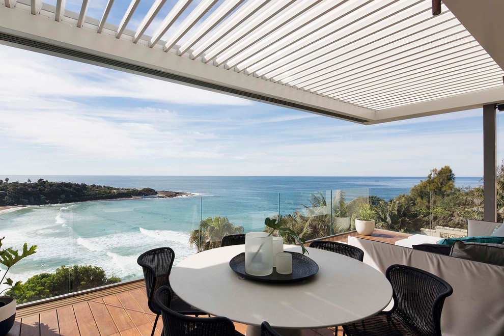 Design ideas for a large coastal back terrace in Sydney with a roof extension.
