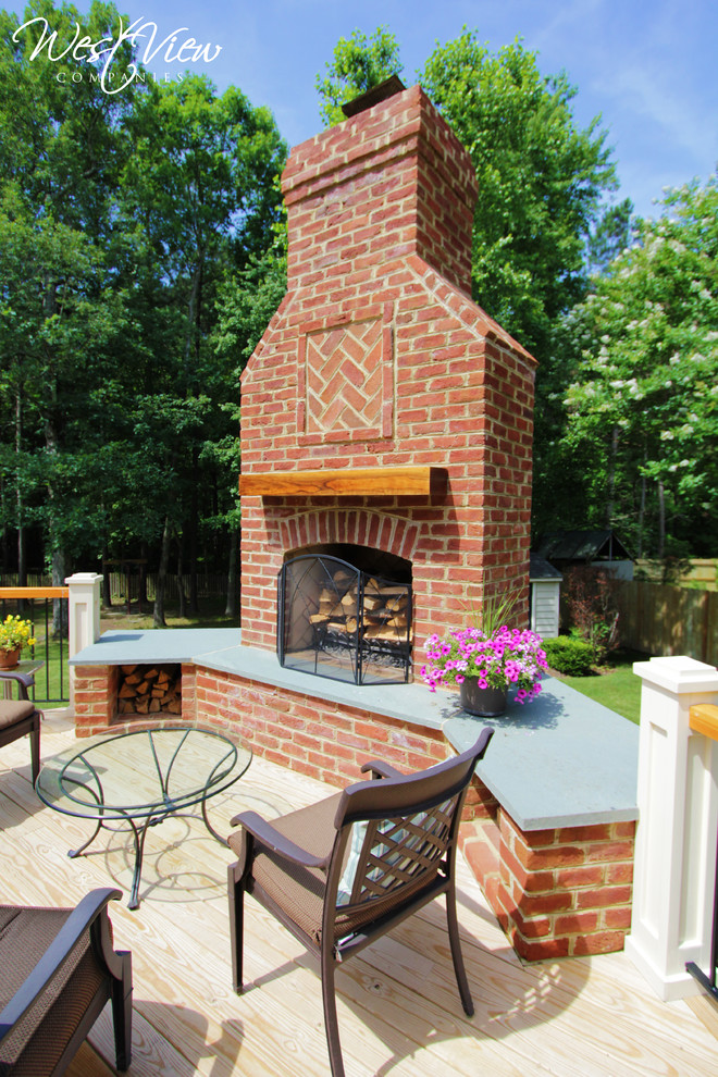 Inspiration for a large timeless backyard deck remodel in Richmond with a fire pit and no cover