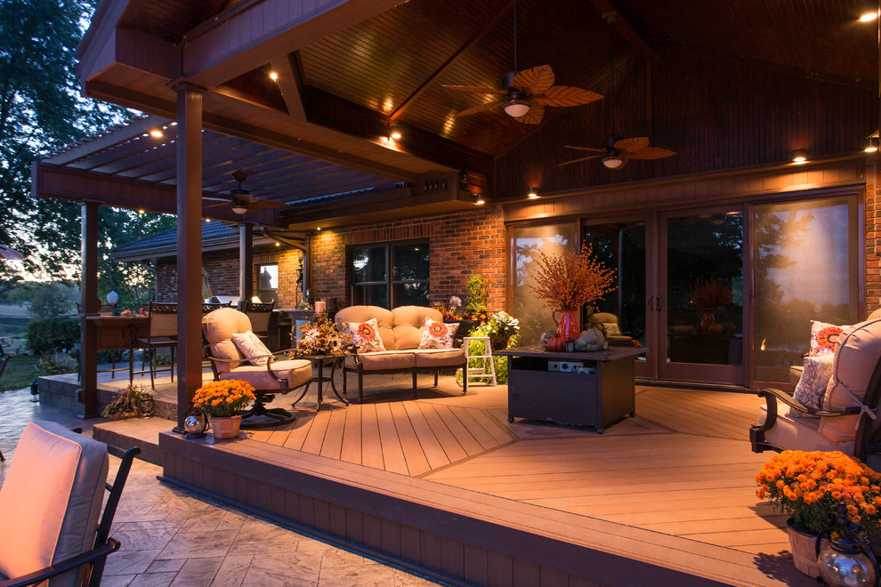 Inspiration for a large timeless backyard outdoor kitchen deck remodel in Kansas City with a pergola