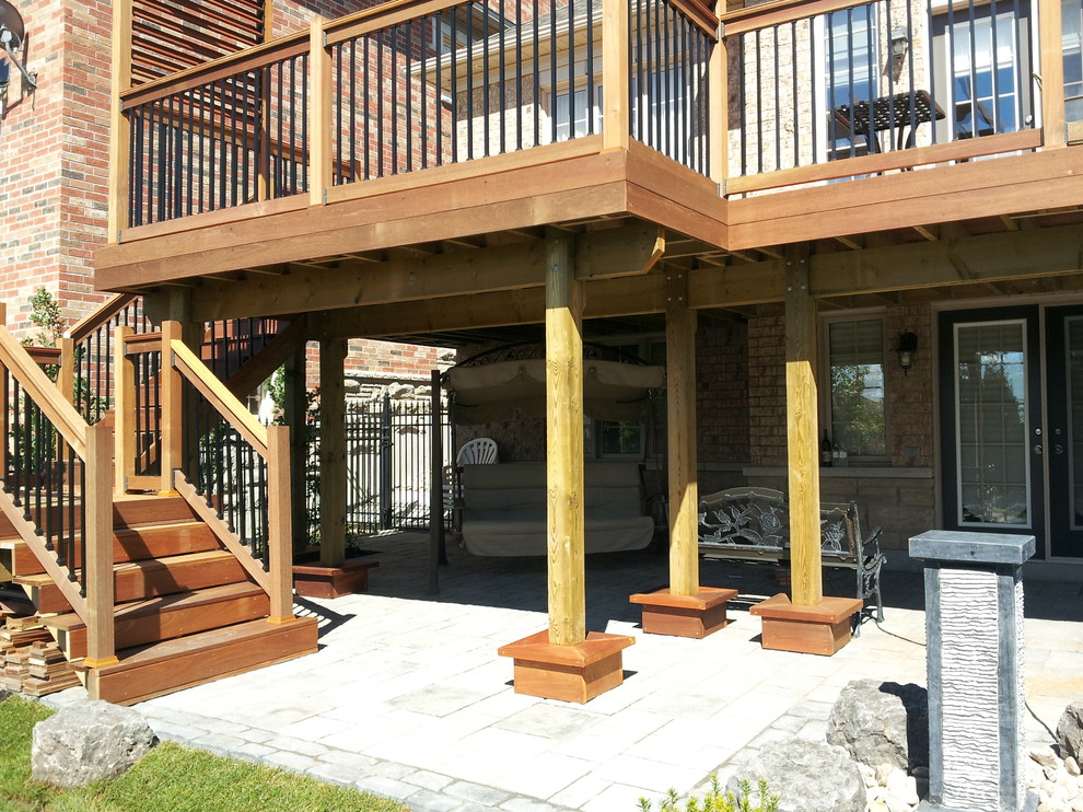Large transitional backyard deck photo in Toronto with no cover