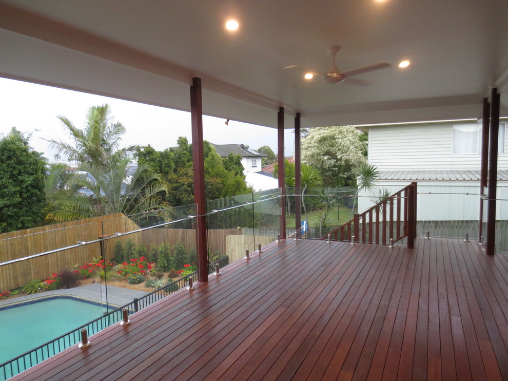 Design ideas for an expansive modern back terrace in Brisbane with a roof extension.