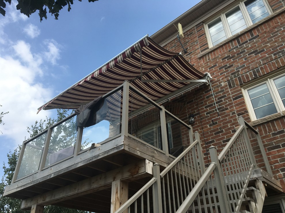 Retractable awning on 2nd level deck with Support Posts Traditional