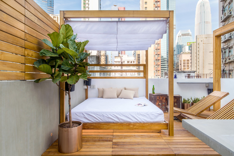 Mid-sized trendy rooftop rooftop deck photo in Hong Kong with a pergola