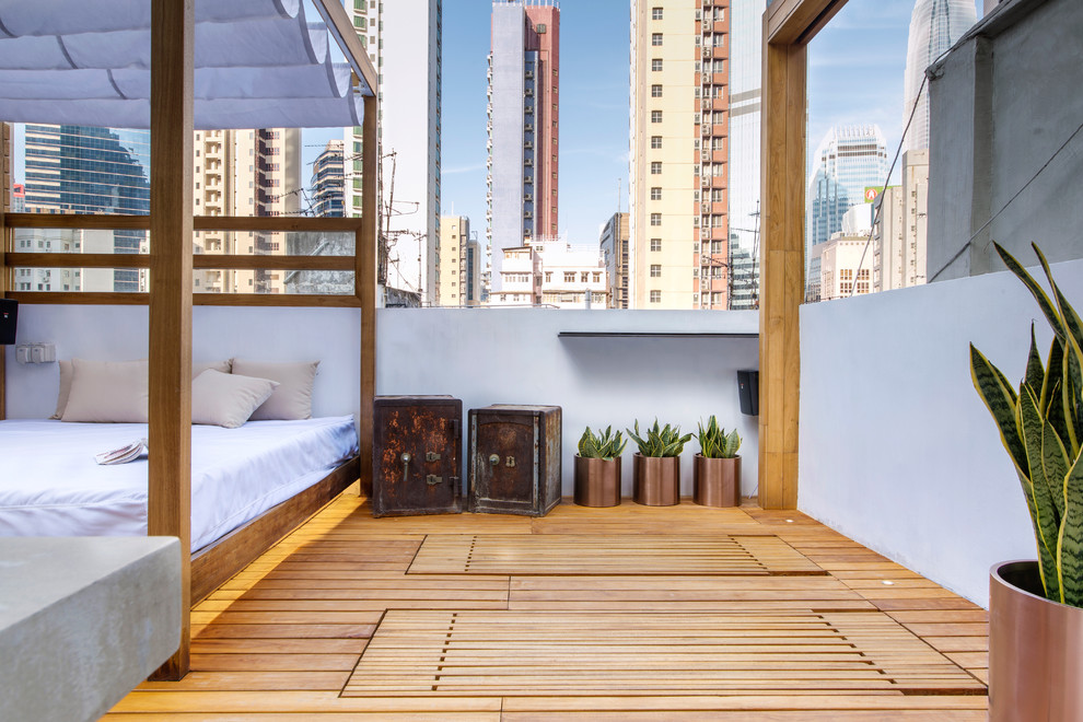 Mid-sized trendy rooftop deck photo in Hong Kong with a pergola