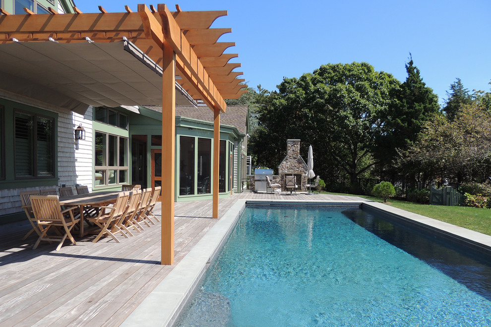 This is an example of a large coastal back terrace in Toronto with a pergola.