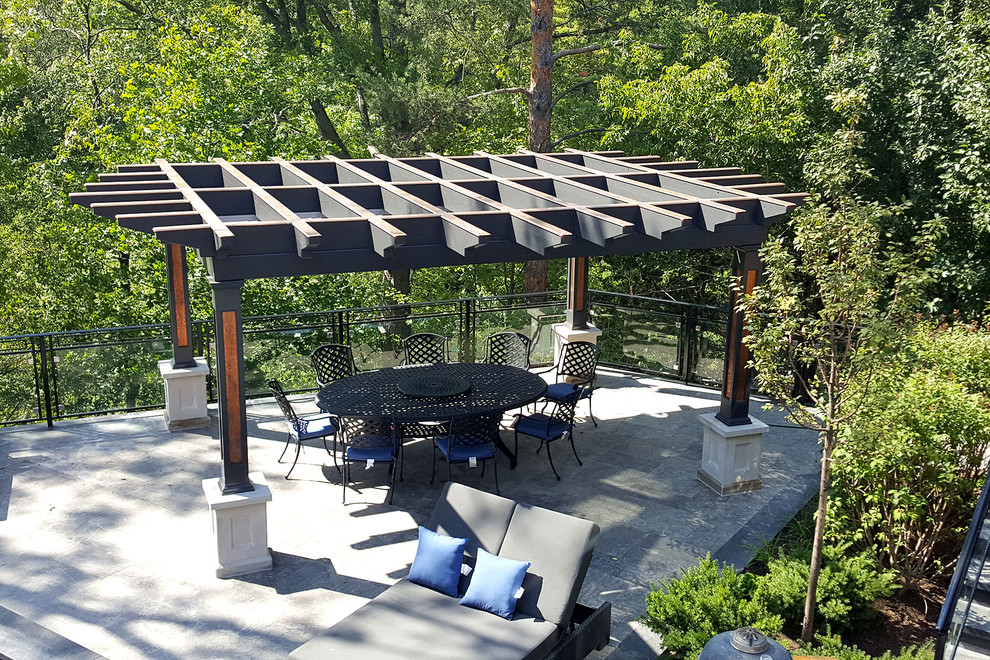 Photo of a large industrial back terrace in Toronto with a pergola.