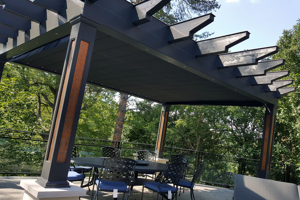 This is an example of a large industrial back terrace in Toronto with a pergola.