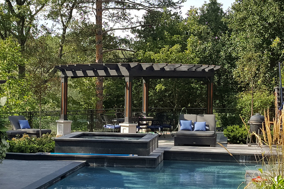 Design ideas for a large industrial back terrace in Toronto with a pergola.