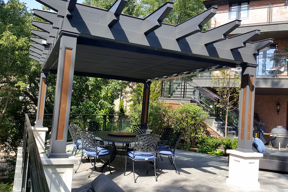 Large urban backyard patio photo in Toronto with a pergola